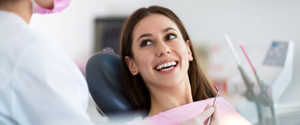 Woman in dental chair smiling